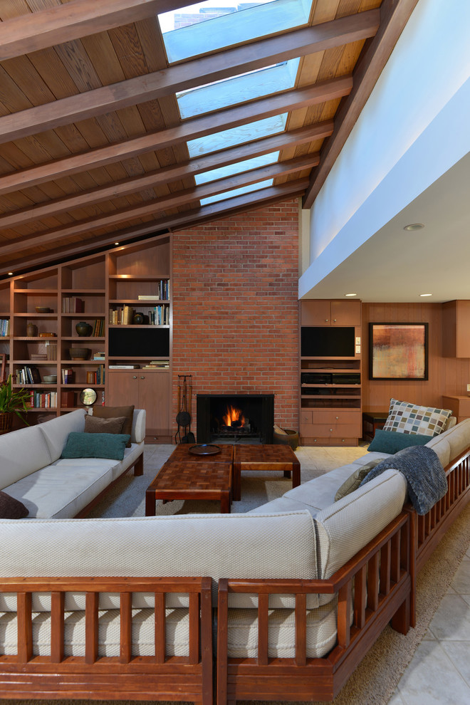 Photo of a midcentury living room in San Diego with a brick fireplace surround.