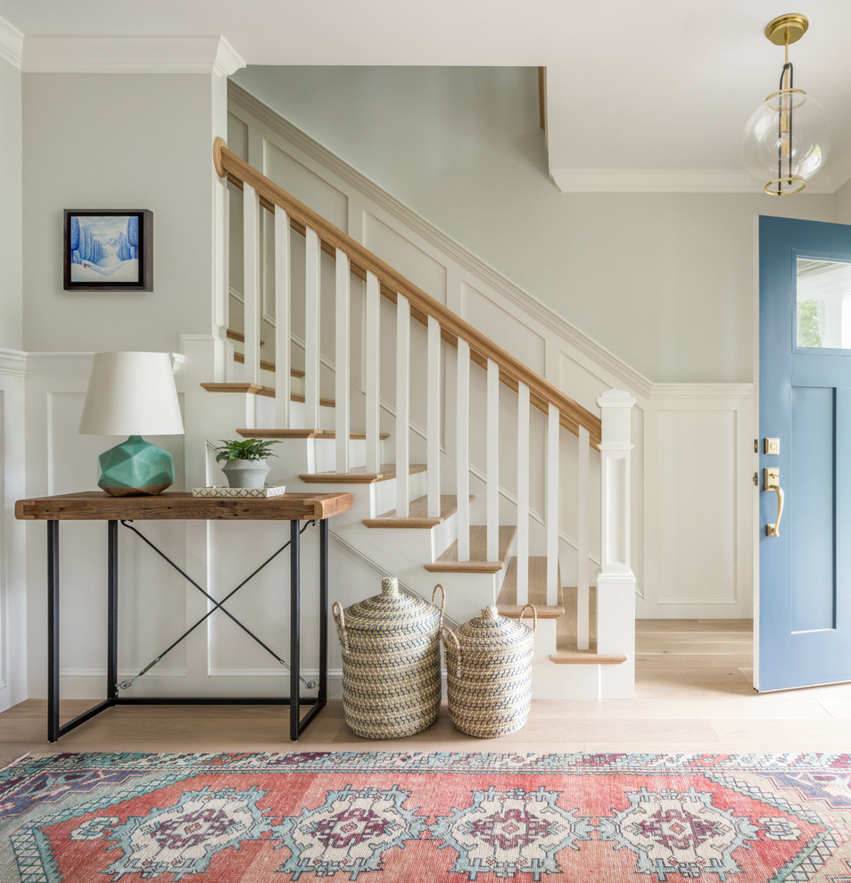 Design ideas for a country foyer in Boston with grey walls, light hardwood floors, a blue front door and beige floor.
