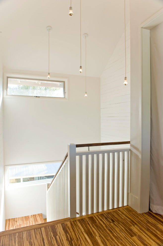 Mid-sized contemporary wood u-shaped staircase in Austin with wood risers.