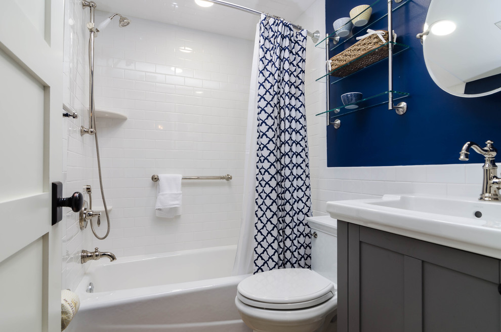 This is an example of a small beach style 3/4 bathroom in Miami with recessed-panel cabinets, grey cabinets, an alcove tub, a shower/bathtub combo, a two-piece toilet, white tile, subway tile, white walls, an integrated sink, engineered quartz benchtops, a shower curtain and white benchtops.