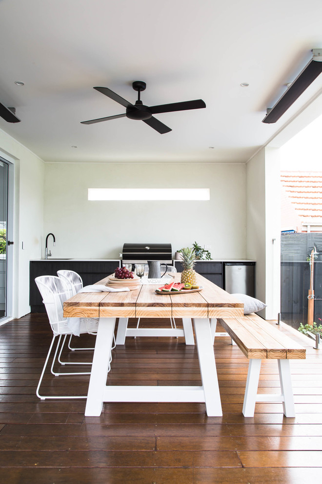 This is an example of a scandinavian backyard patio in Melbourne with decking and a pergola.