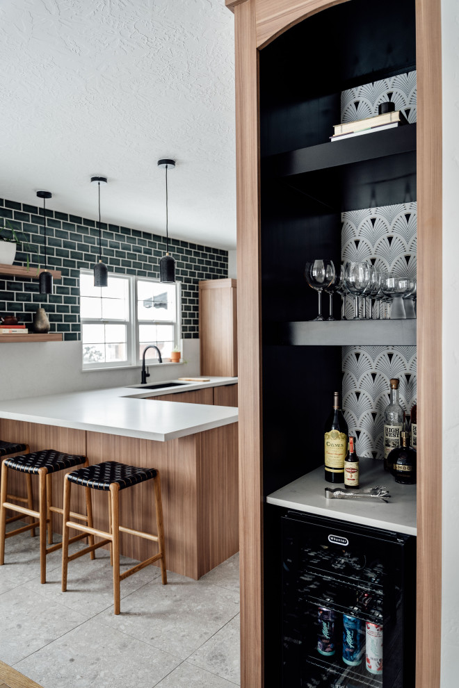 This is an example of a contemporary home bar in Salt Lake City with an undermount sink, medium wood cabinets, grey splashback, grey floor and grey benchtop.