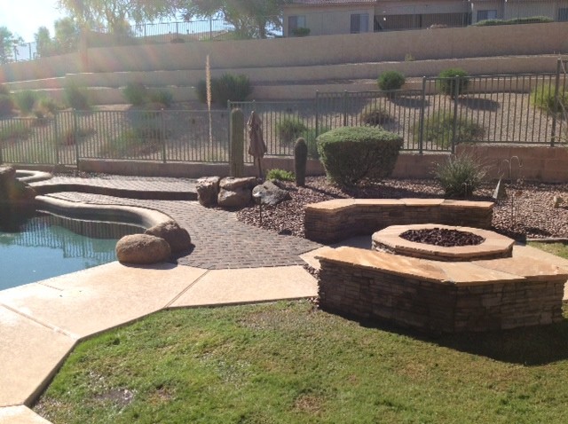 Example of a mid-sized mountain style backyard stone and custom-shaped natural pool design in Phoenix