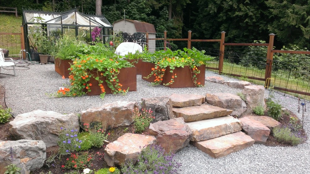 Inspiration for a traditional backyard formal garden in Seattle with with raised garden bed and gravel.