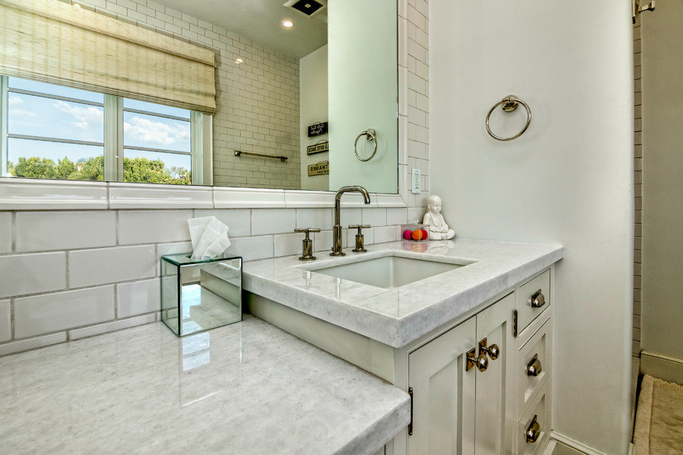 This is an example of a large modern master bathroom in Los Angeles with a freestanding tub and a corner shower.