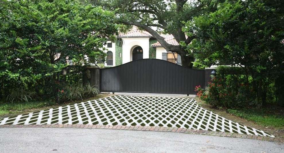 Photo of a small traditional front yard driveway in Miami with brick pavers.