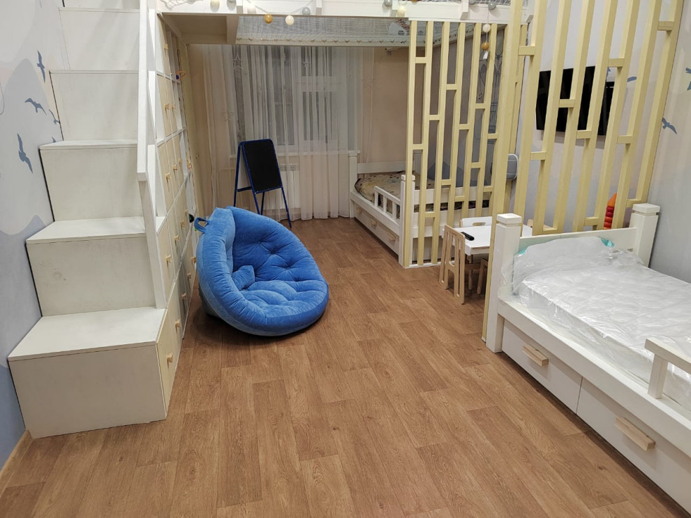 Design ideas for a children’s room for girls in Other with multi-coloured walls, laminate floors and wallpapered walls.