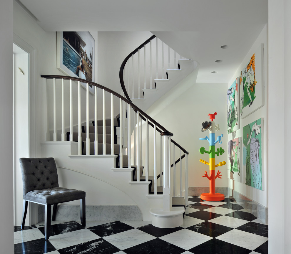 This is an example of a contemporary entryway in London with white walls and multi-coloured floor.