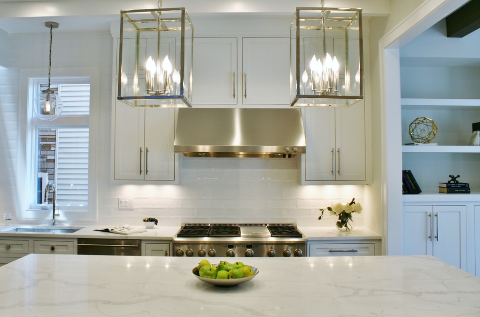 Open concept kitchen - huge transitional galley dark wood floor and brown floor open concept kitchen idea in Chicago with an undermount sink, shaker cabinets, white cabinets, quartz countertops, white backsplash, subway tile backsplash, stainless steel appliances and an island