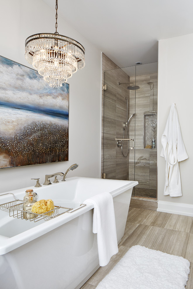 Photo of a large contemporary master bathroom in Toronto with shaker cabinets, medium wood cabinets, a freestanding tub, an alcove shower, a two-piece toilet, gray tile, stone tile, grey walls, marble floors, an undermount sink and engineered quartz benchtops.