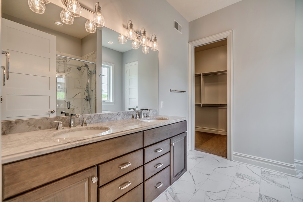 Photo of a transitional master bathroom in Other with raised-panel cabinets, medium wood cabinets, an open shower, a two-piece toilet, gray tile, ceramic tile, grey walls, bamboo floors, an undermount sink, granite benchtops, brown floor, a sliding shower screen and grey benchtops.