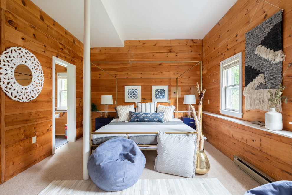 Photo of a large contemporary master bedroom in Portland Maine with brown walls, carpet, beige floor and wood walls.