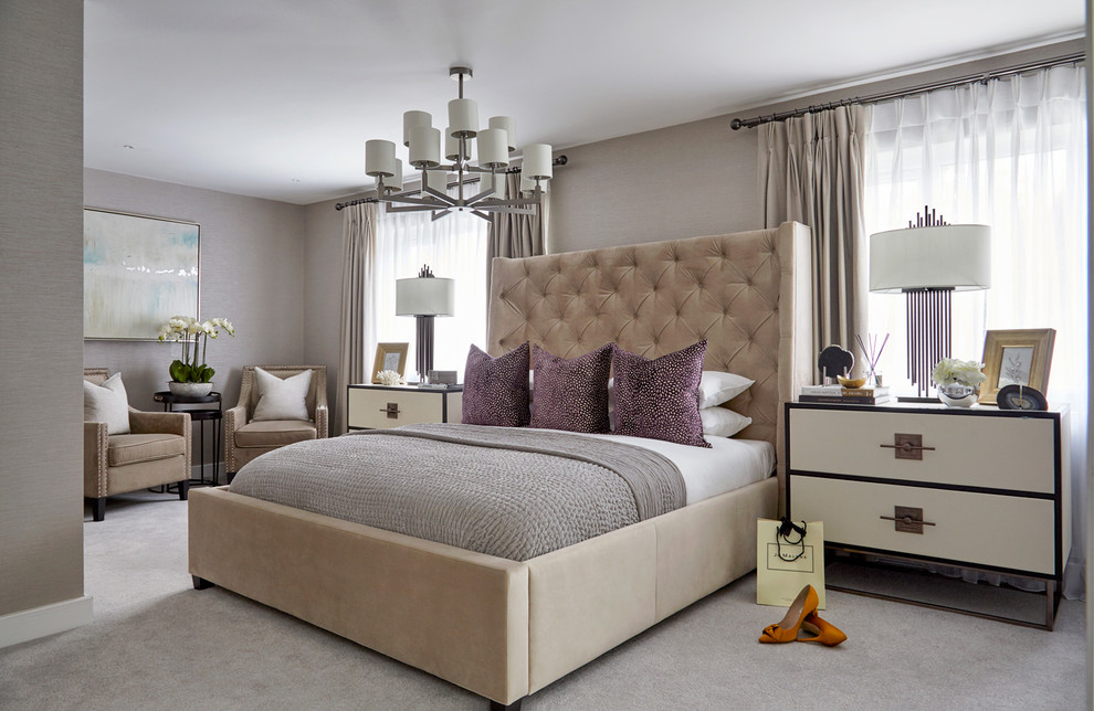 Inspiration for a transitional bedroom in London with beige walls, carpet and grey floor.