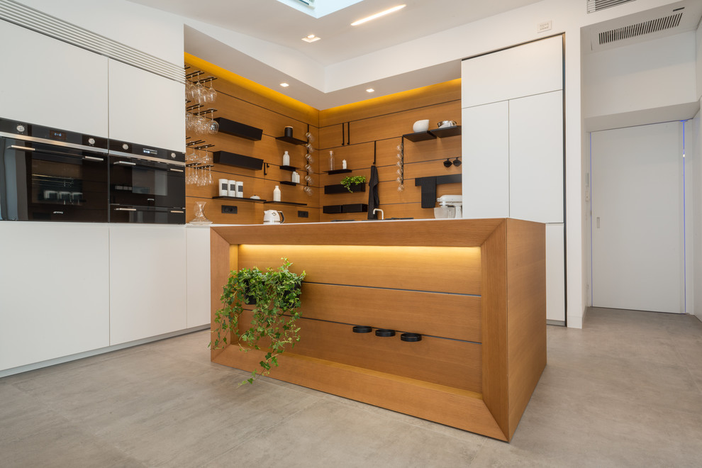 Design ideas for a contemporary l-shaped open plan kitchen in Naples with flat-panel cabinets, white cabinets, black appliances, porcelain floors and with island.