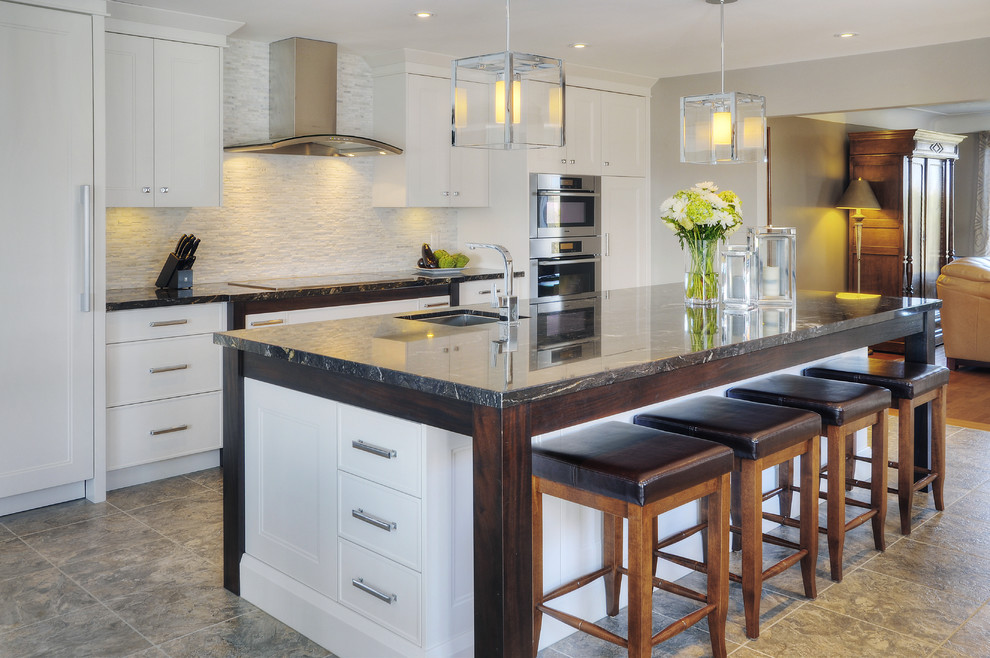 This is an example of a large contemporary eat-in kitchen in Toronto with an undermount sink, recessed-panel cabinets, white cabinets, granite benchtops, stainless steel appliances and with island.