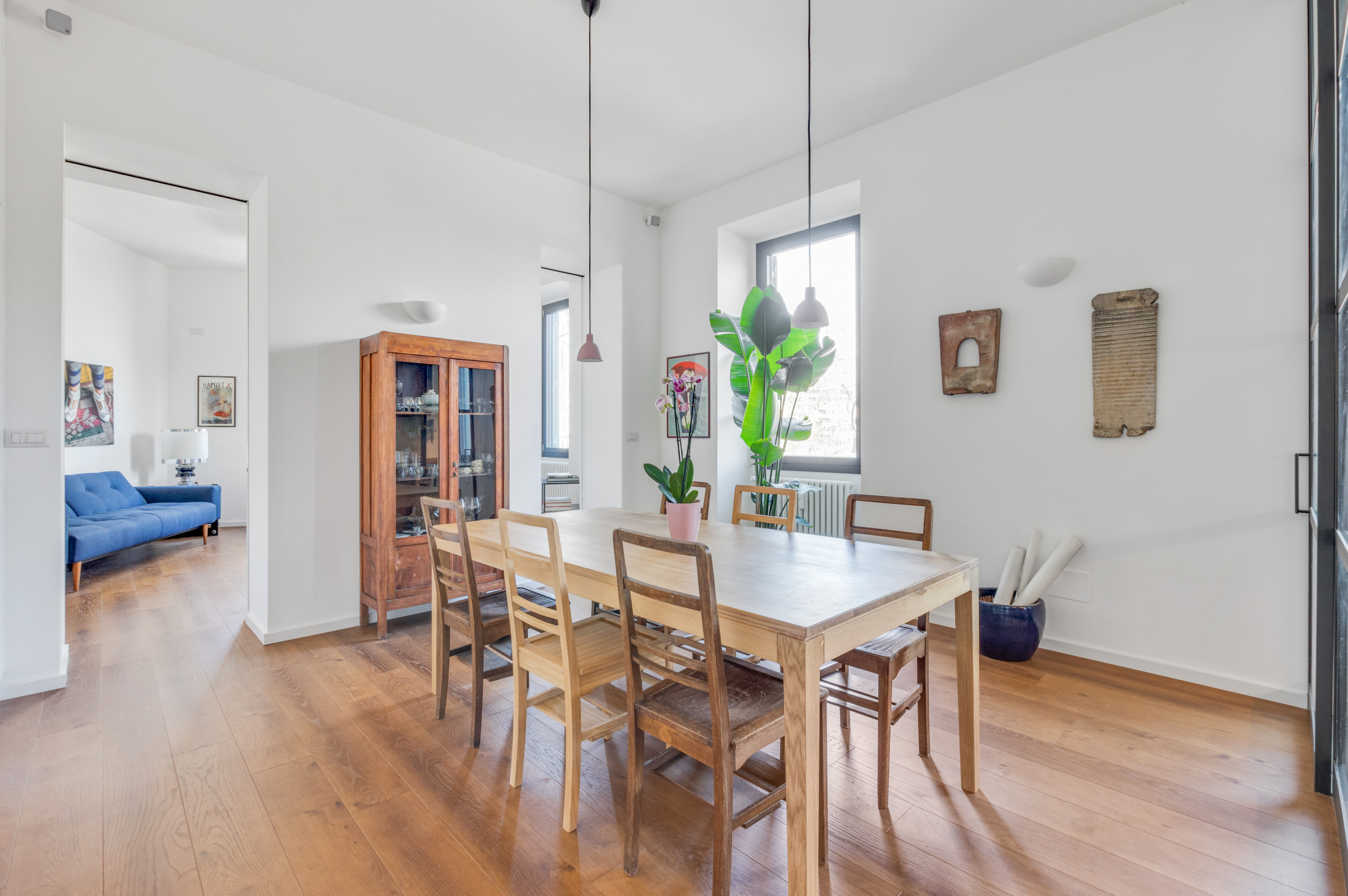 Large dark wood floor and brown floor kitchen/dining room combo photo in Rome with white walls