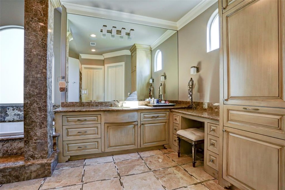Photo of a large mediterranean master bathroom in Houston with furniture-like cabinets, distressed cabinets, a drop-in tub, an alcove shower, pink tile, marble, pink walls, marble floors, an undermount sink, granite benchtops, beige floor, a hinged shower door and pink benchtops.