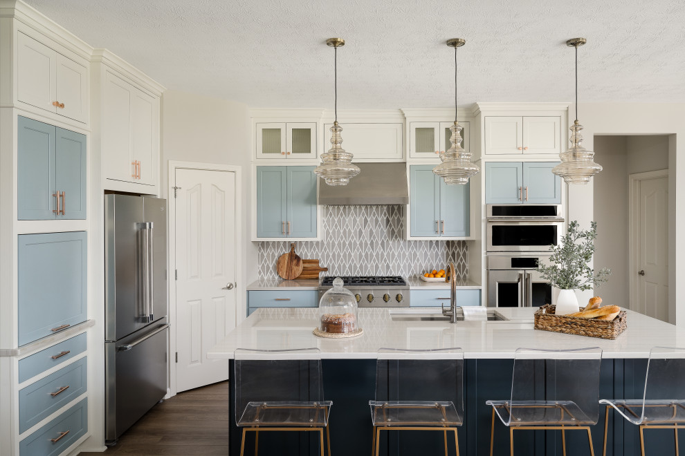 Design ideas for a mid-sized modern l-shaped eat-in kitchen in Indianapolis with an undermount sink, shaker cabinets, blue cabinets, quartz benchtops, stainless steel appliances, medium hardwood floors, with island and white benchtop.
