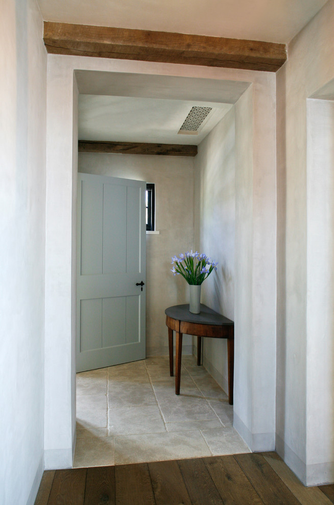 Photo of a beach style entryway in Orange County with a single front door and a gray front door.