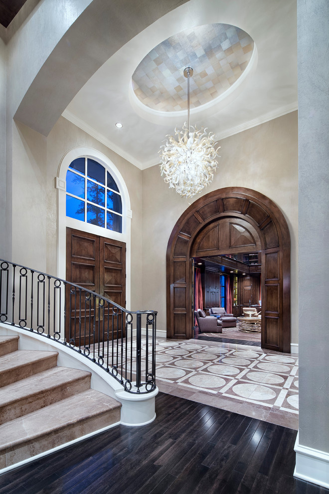 Traditional foyer in Houston with beige walls, a double front door and a dark wood front door.