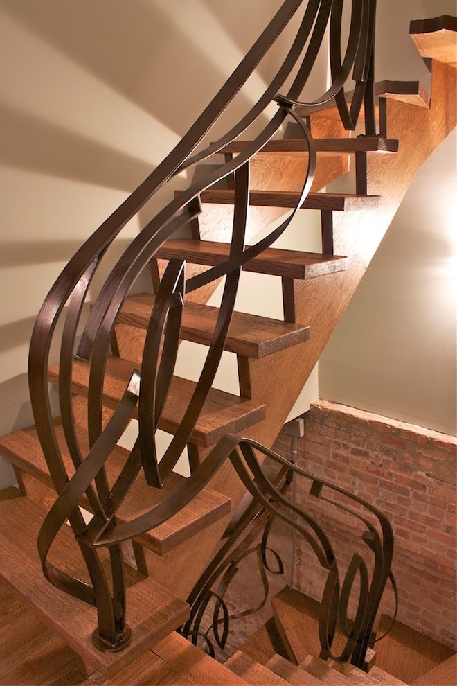 Photo of a mid-sized eclectic wood u-shaped staircase in Chicago with open risers.