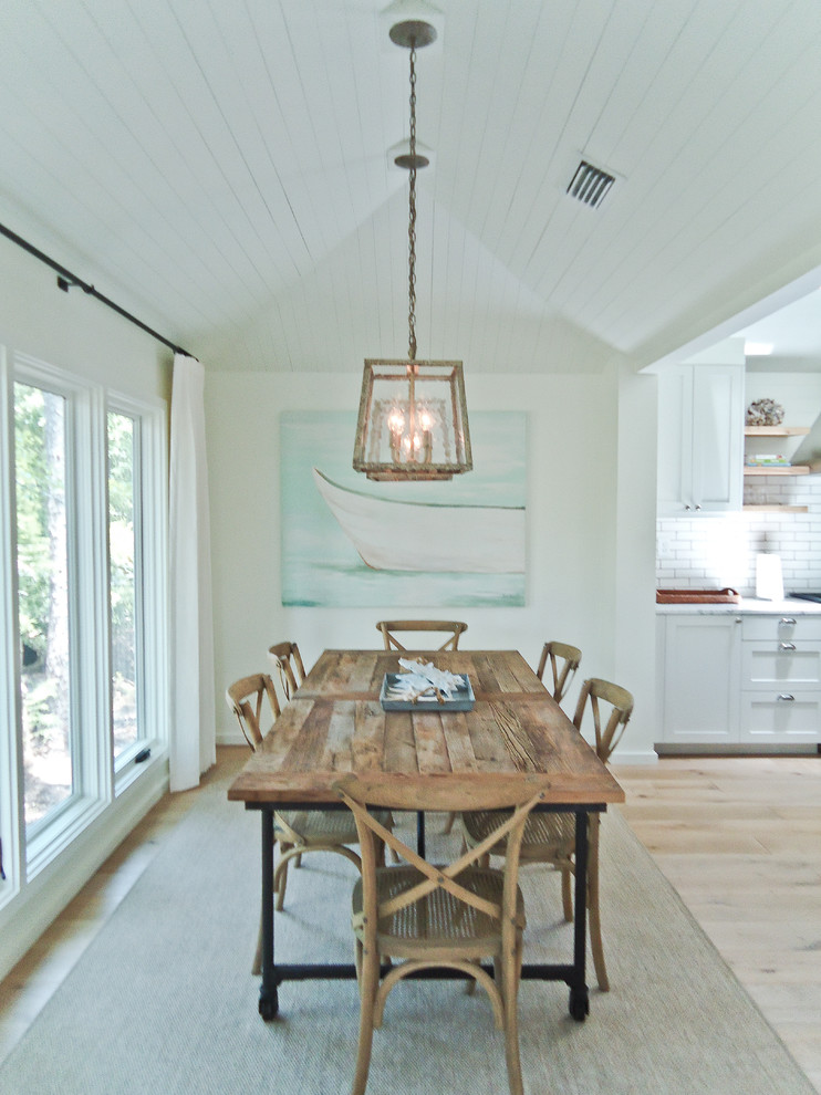 Inspiration for a small beach style dining room in Miami with white walls and light hardwood floors.
