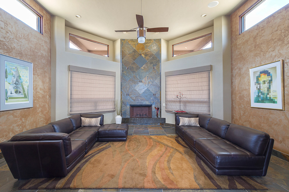 Design ideas for a large modern open concept living room in Phoenix with multi-coloured walls, slate floors, a standard fireplace and a stone fireplace surround.