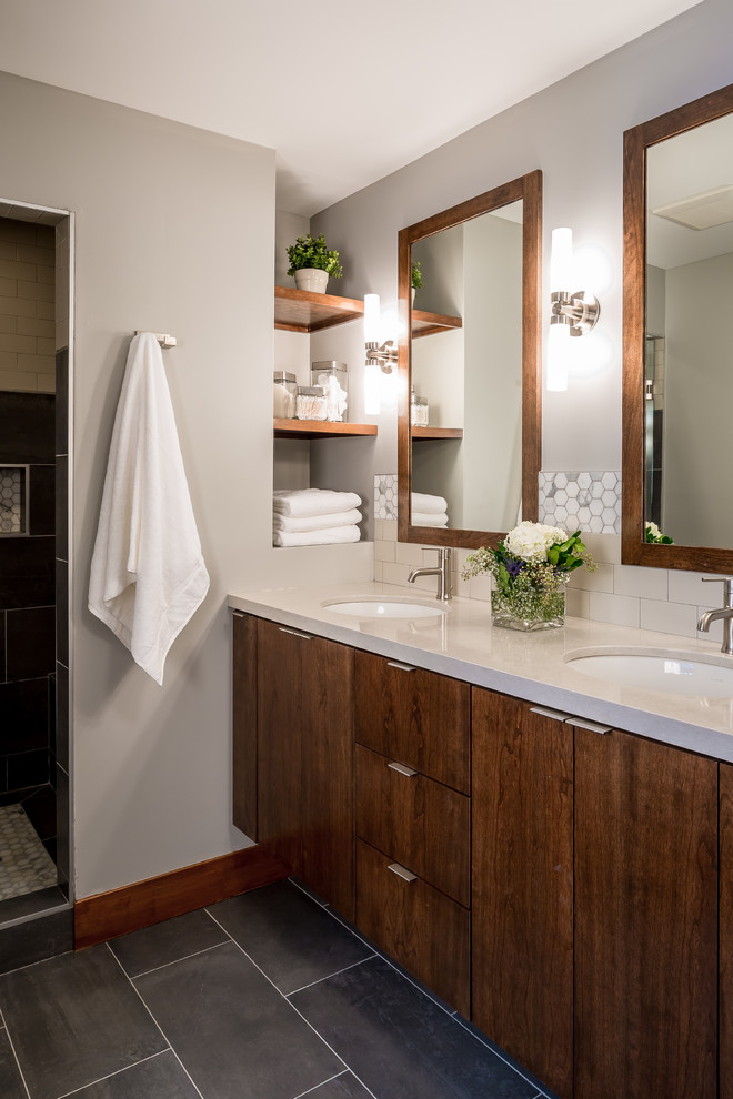 This is an example of a contemporary master bathroom in Minneapolis with flat-panel cabinets, medium wood cabinets, engineered quartz benchtops, porcelain tile, porcelain floors, an undermount sink, an alcove shower, beige tile and grey walls.
