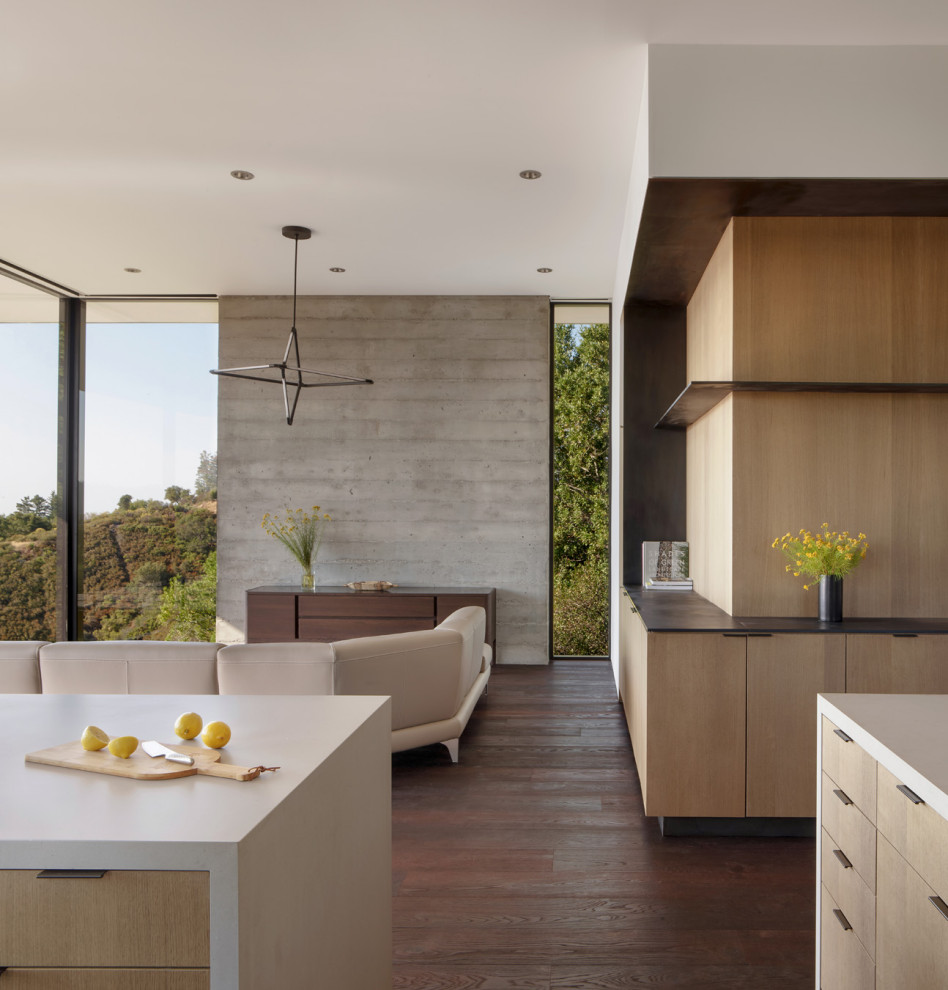 Design ideas for a mid-sized modern l-shaped eat-in kitchen in San Francisco with an undermount sink, flat-panel cabinets, medium wood cabinets, quartz benchtops, black splashback, window splashback, stainless steel appliances, dark hardwood floors, with island, brown floor and white benchtop.