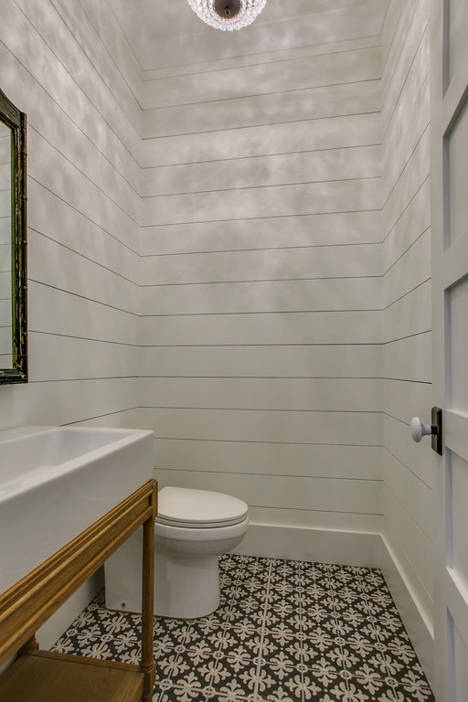 This is an example of a small country 3/4 bathroom in Nashville with a two-piece toilet, ceramic tile, white walls, ceramic floors, a console sink and solid surface benchtops.