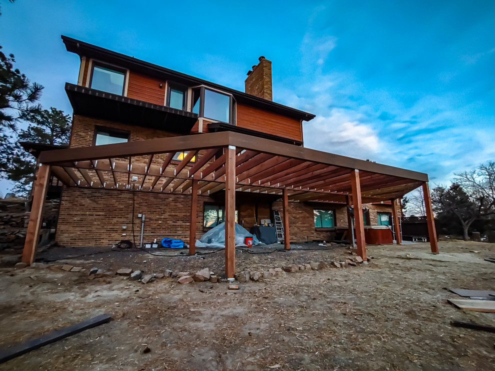 Example of a large minimalist backyard second story metal railing deck design in Denver with no cover