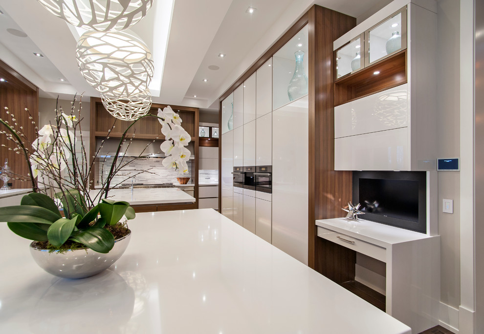Large contemporary l-shaped eat-in kitchen in Calgary with a triple-bowl sink, flat-panel cabinets, white cabinets, quartzite benchtops, multi-coloured splashback, matchstick tile splashback, stainless steel appliances, dark hardwood floors and with island.