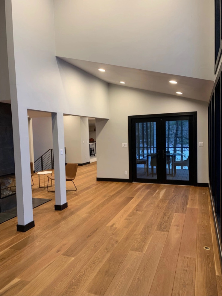 Contemporary open concept living room in Boston with medium hardwood floors.