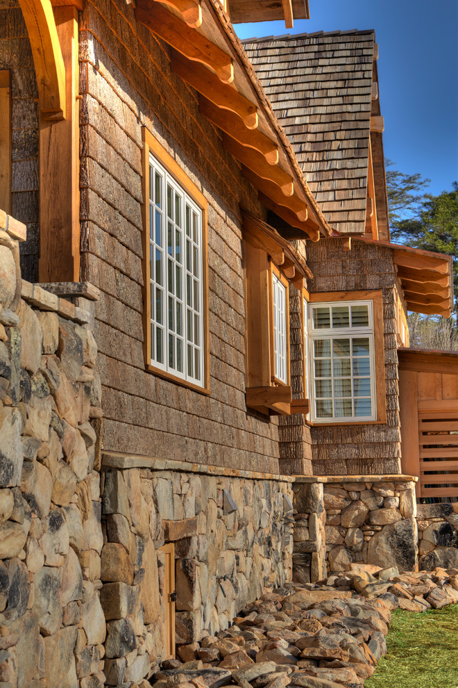 Inspiration for a large rustic gray two-story stone exterior home remodel