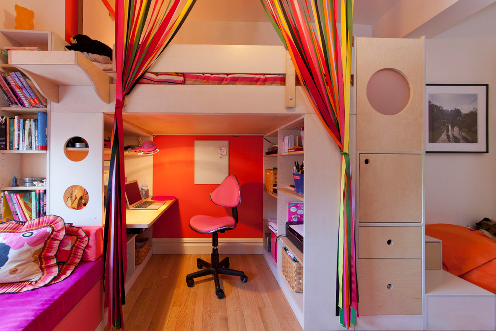 This is an example of a small contemporary kids' room for girls in New York with multi-coloured walls and light hardwood floors.