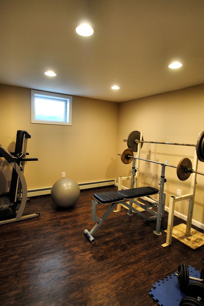 Photo of a mid-sized traditional home weight room in New York with beige walls and vinyl floors.