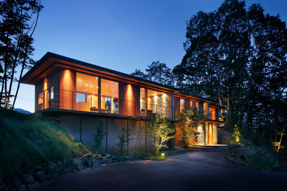 Photo of a contemporary exterior in Other with wood siding and a flat roof.