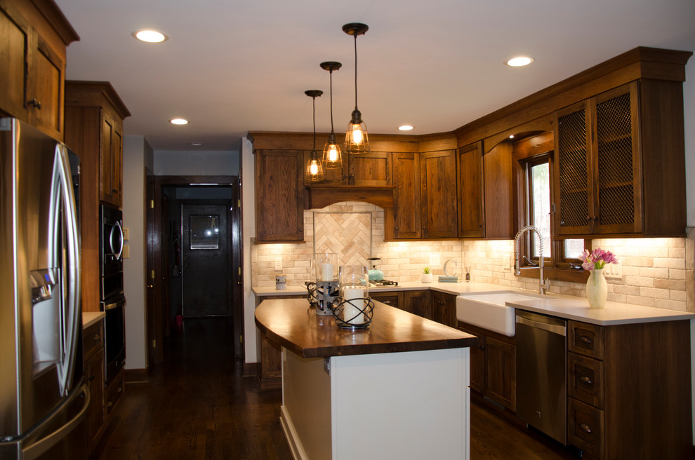 Photo of a separate kitchen in Raleigh with dark wood cabinets, granite benchtops, beige splashback, travertine splashback, dark hardwood floors, with island and brown floor.