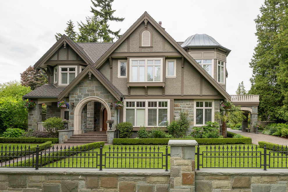 This is an example of a large traditional two-storey brown exterior in Vancouver with mixed siding and a gable roof.