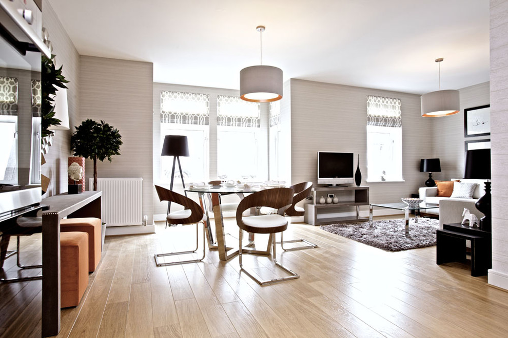 This is an example of a contemporary dining room in Glasgow with beige walls.