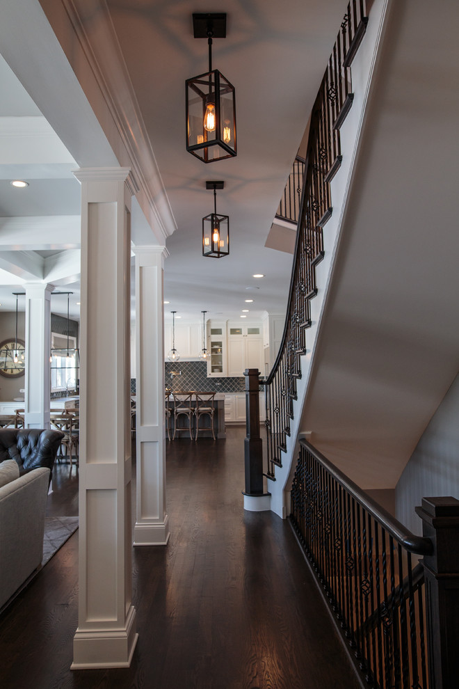 This is an example of a large transitional wood straight staircase in Chicago with painted wood risers.