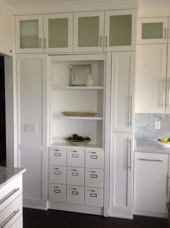 Enclosed kitchen - mid-sized transitional single-wall dark wood floor and brown floor enclosed kitchen idea with shaker cabinets, white cabinets, marble countertops, white backsplash, stone slab backsplash and no island