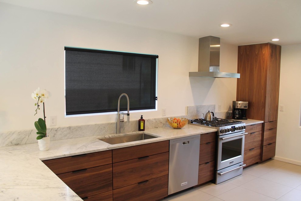 This is an example of a mid-sized contemporary l-shaped separate kitchen in New York with an undermount sink, flat-panel cabinets, dark wood cabinets, granite benchtops, stainless steel appliances, porcelain floors, a peninsula, grey floor and grey benchtop.