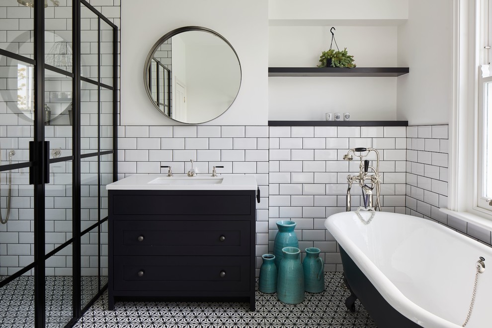 Design ideas for a country master bathroom in London with flat-panel cabinets, black cabinets, a claw-foot tub, a curbless shower, white tile, subway tile, white walls, an undermount sink, multi-coloured floor, a hinged shower door and white benchtops.
