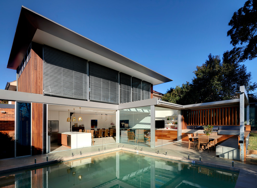Large contemporary two-storey brown exterior in Sydney with wood siding and a flat roof.