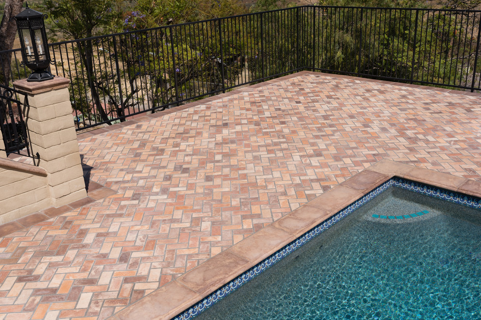 Inspiration for a large mediterranean courtyard rectangular pool in Orange County with tile.