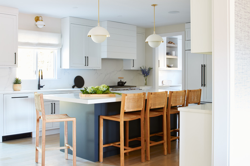 Inspiration for a mid-sized modern u-shaped separate kitchen in New York with an undermount sink, shaker cabinets, white cabinets, quartzite benchtops, white splashback, stone slab splashback, stainless steel appliances, light hardwood floors, with island, beige floor and white benchtop.