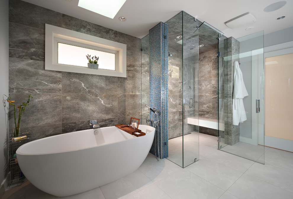 This is an example of a large contemporary master bathroom in Vancouver with a freestanding tub, marble, a hinged shower door, a curbless shower, gray tile, grey walls and grey floor.