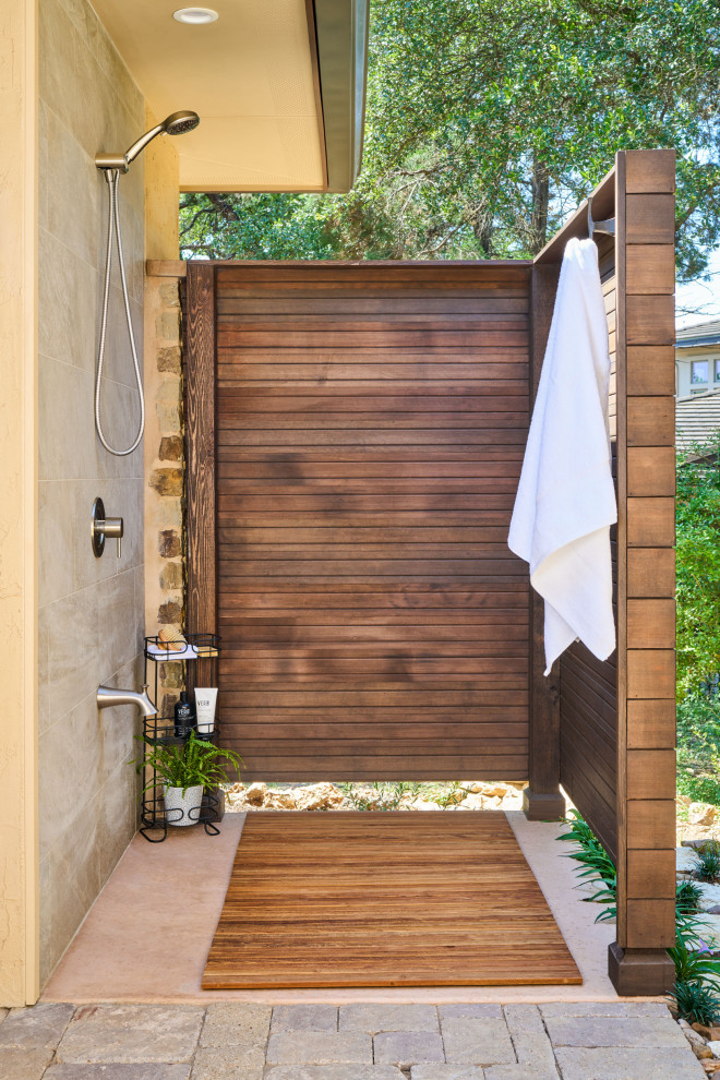 Small contemporary side patio in Austin with an outdoor shower, concrete slabs and an awning.