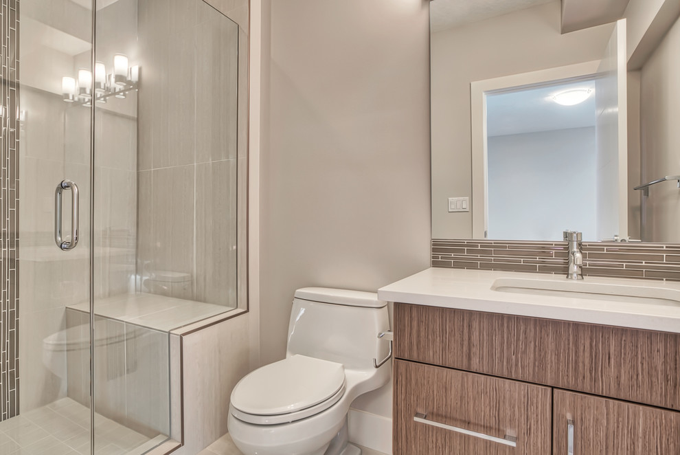 This is an example of a contemporary bathroom in Calgary with flat-panel cabinets and an undermount sink.